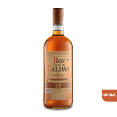 Botella de Ron Viejo de Caldas Tradicional de 1000ml sobre fondo blanco. La botella de cristal muestra el licor ámbar oscuro y una etiqueta clásica en tonos dorados con el logo distintivo de la marca e ilustraciones de aves.